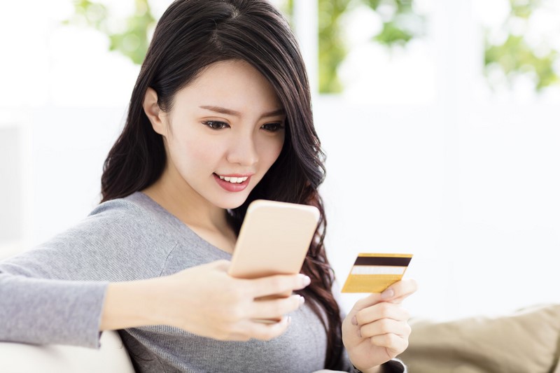 young beautiful woman with credit card and smart phone